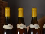 four bottles of wine are lined up on a table