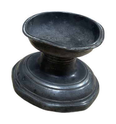 a black bowl sitting on a pedestal on a white background