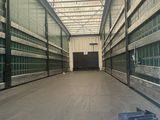 a large warehouse with a lot of windows and a lot of boxes