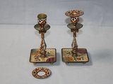 pair of antique brass candlesticks with floral designs on them