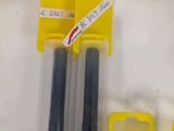 three pens that are next to each other on a table