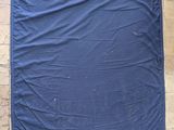 a blue tarp hanging on the side of a building