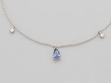 a blue sapphire and diamond necklace on a silver chain