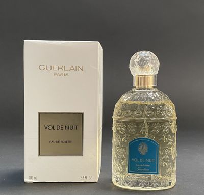 an image of a bottle of perfume next to a box of perfume