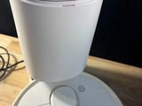 a white robot sitting on top of a wooden table