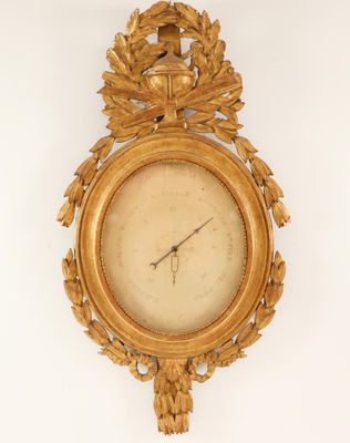 a gold clock on the wall with a bird on it
