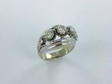 a close up of a diamond ring on a white surface
