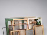 a lot of picture frames sitting on a table