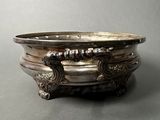 a silver bowl that is sitting on a table