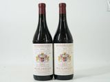 deux bouteilles de vin posées l'une à côté de l'autre sur une surface blanche