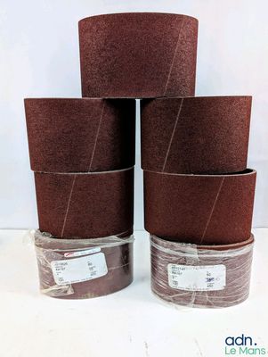 a set of four brown sandpaper rolls sitting on top of each other