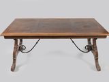 an old wooden table with iron legs and a wooden top