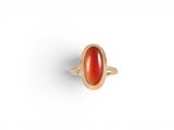 a gold ring with a carnel stone in the center
