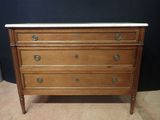 an antique chest of drawers with marble top