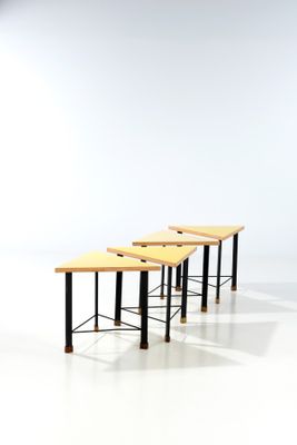 three wooden benches sitting on top of a white floor next to each other