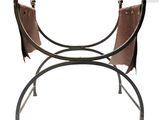 a metal bench with two leather chairs on it