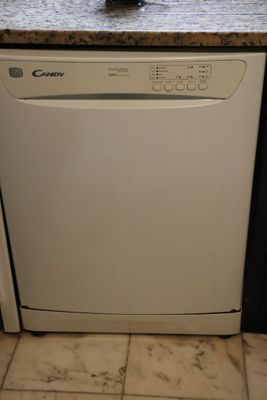 a white dishwasher sitting in a kitchen next to a counter