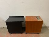 two black and wood nightstands with a drawer on top of them
