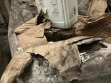 a white container sitting on top of a pile of cardboard