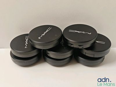 four mac cosmetics containers are stacked on top of each other