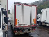 two trucks parked next to each other in a parking lot