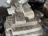 a pile of bricks stacked on top of a pile of buckets