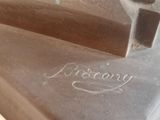 a close up of a piece of metal with a hammer on it