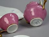 two cups and a saucer sitting on a table