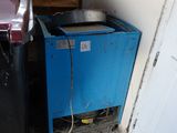 a blue trash can and a black trash can in the corner of a room