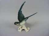 a small figurine of a bird that is sitting on a table