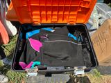 a suitcase with a wet suit in it sitting on the ground