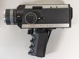 a black and silver camera mounted on a wall