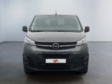 the front of a grey van is parked in a white room