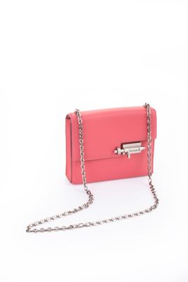 a pink purse with a chain hanging from it ' s side