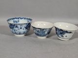 three blue and white porcelain bowls sitting on top of a table