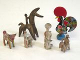 many figurines of different shapes and sizes on a white surface