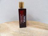 a close up of a bottle of perfume on a wooden table