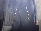 two jackets that are hanging on a wall