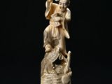 chinese carved ivory figurine of an angel and a bird on a basket