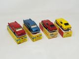 four toy cars are lined up in a row on a white surface