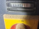 a close up of a gas pump with a red knob