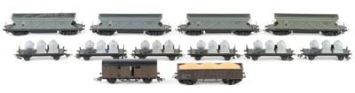 a lot of different types of toy trains on the tracks