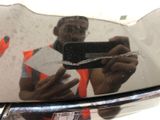 a man taking a picture of himself in the rear view mirror of a car