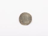 a close up of a coin on a white surface