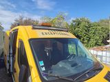 a yellow van that is parked next to a trailer
