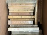 a box full of books that are stacked on top of each other