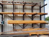 several pieces of wood are stacked on top of each other in front of a building