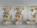 three glass vases sitting next to each other on a table