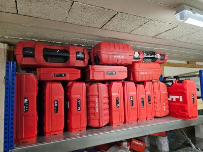 de nombreuses caisses à outils rouges posées sur une étagère dans un garage