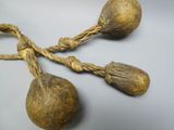 two large wooden balls tied together with rope on a table